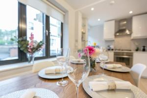 a dining room table with wine glasses on it at Urban Chic - Basing Street in London