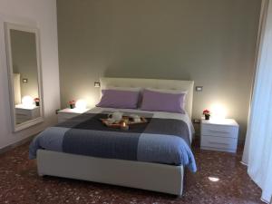 a bedroom with a large bed with purple pillows at Sweet Home Roma in Rome