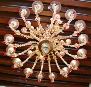 a chandelier hanging from the ceiling of a room at Pesaro Palace in Venice