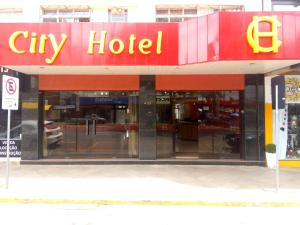 a city hotel with a sign on the front of it at City Hotel PF in Passo Fundo