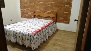 a bedroom with a bed with a blanket on it at Recanto Shambala in São Thomé das Letras +17 photos