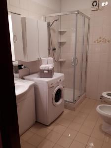 a bathroom with a washing machine and a shower at Casa Camilla CIR 0058 in Aosta