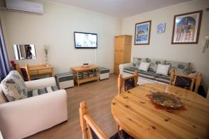 a living room with a table and a couch at Complex Apolon in Nesebar