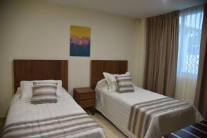 Ένα ή περισσότερα κρεβάτια σε δωμάτιο στο Suites San Pedro