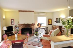 a living room with a couch and a fireplace at Gite Au Bouzigues in Monlaur-Bernet