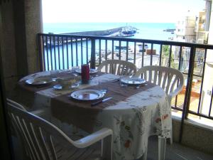a table on a balcony with a view of the ocean at Vistas al mar y cerca de la playa in L'Ametlla de Mar
