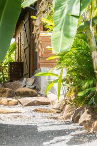 a stone walkway in front of a house at Iguana Ecolodge in Saint-François