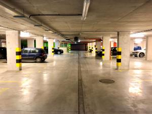 an empty parking garage with cars parked in it at WrocApartments StarCenter in Wrocław