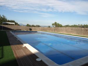 a swimming pool with blue water on a roof at Aparthotel del Golf in Sant Cugat del Vallès