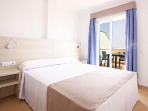 Postel nebo postele na pokoji v ubytování AReH Apartamentos