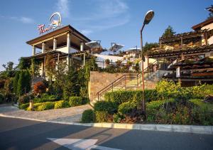 a building with a sign on the side of a street at Santa Marina Apartment 513 in Sozopol