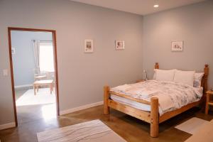 a bedroom with a bed and a mirror at Baergnaescht B&B in Osoyoos
