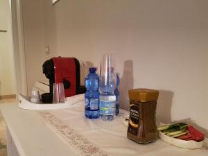 a table with bottles of water and other items on it at Foresteria Borgo Delle Grazie in Curtatone