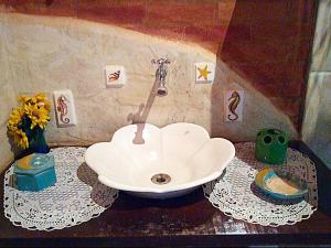 a bathroom with a sink on a table at Recanto Marazul in Ubatuba