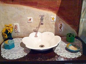 a bathroom with a sink on a table at Recanto Marazul in Ubatuba +26 photos