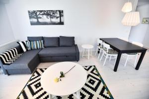 a living room with a couch and a table at Airport Residence 2 in Otopeni