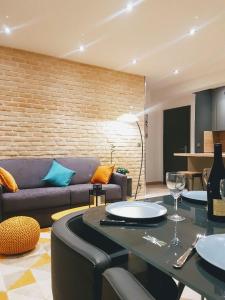 a living room with a couch and a table at Central Sweet Home in Saint-Gervais-les-Bains