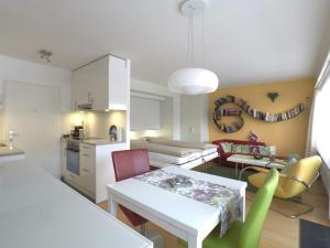 a kitchen and living room with a table and chairs at Haus Belmont in Zermatt