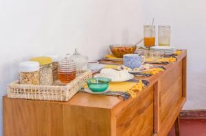 a wooden dresser with food on top of it at Pouso copo de leite in Tiradentes