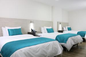 Postel nebo postele na pokoji v ubytování Arame Hotel