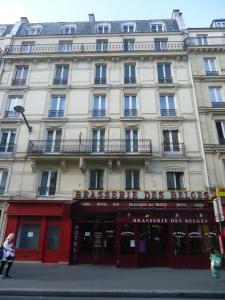 a large building on the corner of a street at Hotel des Belges in Paris
