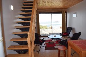 a staircase leading up to a living room with a table and chairs at Mar de Lobos in Matanzas