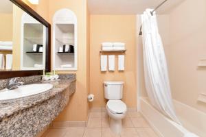 a bathroom with a toilet and a sink and a shower at Hampton Inn & Suites Cathedral City in Cathedral City