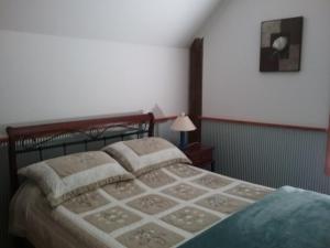 a bedroom with a bed and a lamp in it at Lyrebird Gully Retreat in Hallston