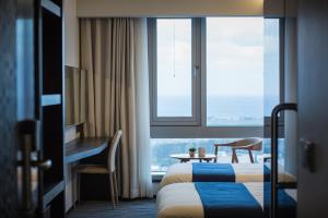Postel nebo postele na pokoji v ubytování Gloucester Hotel Jeju