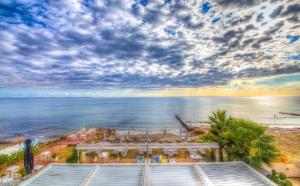 a view of the beach and the ocean from a building at Island Boutique Hotel in Larnaca