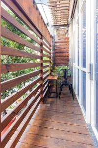 a wooden privacy fence on a porch with a bench at Chinhsi Homestay in Longjing