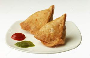 two tortilla parcels on a white plate with ketchup at Hotel Royal Castle in Mumbai
