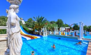 a group of people in a pool at a water park at Creta guesthouse ARXONTIKO! in Smárion
