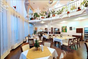 a restaurant with tables and chairs and a balcony at AselTur Brasov in Braşov