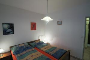 a small bedroom with a bed and a lamp at Talstrasse 24 - Buff in Davos