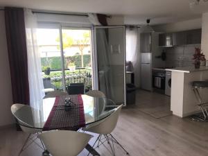 a dining room and kitchen with a table and chairs at Domaine de Bussy in Bussy-Saint-Georges