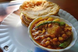 a plate of food with a bowl of beans and toast at Lake Land Guest House in Kolkata +18 photos
