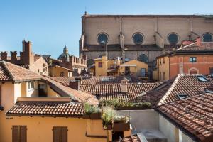 a view of a city with roofs and a large building at Art Hotel Orologio in Bologna