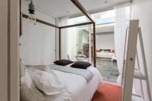 a bedroom with a large bed with white sheets and pillows at M Costa Nova in Costa Nova +44 photos