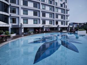 a large swimming pool in front of a building at Pullman Hanoi in Hanoi