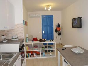 a kitchen with a blue door on the wall at Casa vacanza Irma Dario in San Vito lo Capo