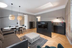 a living room with a couch and a table at Apartments Rog in Ljubljana