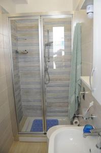 a bathroom with a shower with a toilet and a sink at Casa vacanza Irma Dario in San Vito lo Capo