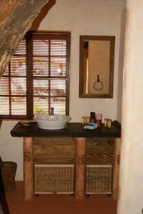 a bathroom with a sink and a mirror at Weltevreden Country Guest Lodge in Groblersbrug