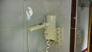 a blow dryer is hanging on a wall at Hotel Valdoviño in Valdoviño