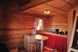 a kitchen with a sink in a wooden cabin at Les Cabanes du Trappeur in Wentworth-Nord