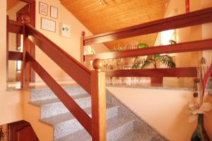 a staircase in a house with a wooden railing at Hospedaje Pension Tabares in Zas
