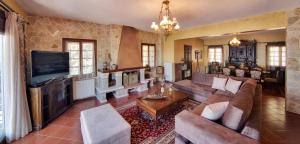 a living room with a couch and a tv at Infinity Villa Ioannina in Ioannina