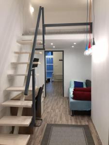 a living room with a staircase and a couch at The Whistling Rabbi in Budapest