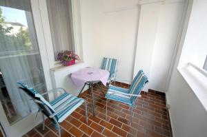 a patio with two chairs and a table on a balcony at Mezlar Apartment in Njivice